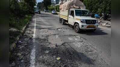 Broken carriageway, parking chaos, potholes choke key Udyog Vihar link