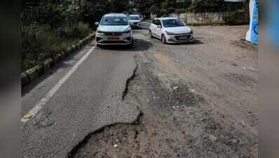 Broken carriageway, parking chaos, potholes choke key Udyog Vihar link