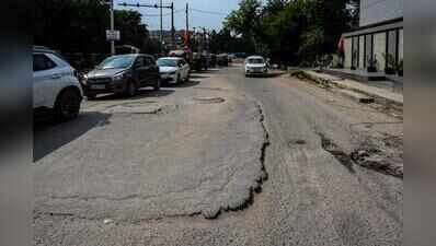 Broken carriageway, parking chaos, potholes choke key Udyog Vihar link