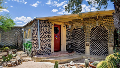 In 1964, an Arizona couple began building a carport with discarded bottles; years later, the project had grown into a 2,700-sq-ft home made with thousands of bottles and listed for $432,500