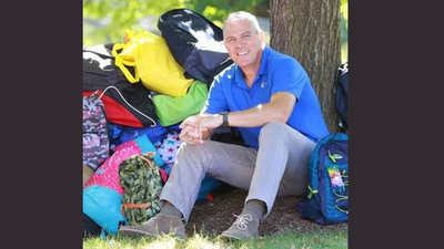 In 2013, Rob Scheer began packing backpacks at his dining table after recalling carrying his belongings in trash bags as a foster child; his charity has distributed 300,000+ backpacks