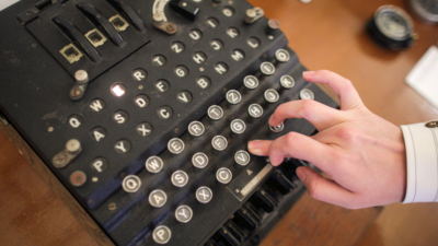 A Romanian flea-market seller thought an old machine was a typewriter and let it go for €100; the buyer, a cryptography professor, recognized a World War II Enigma I and sold it at auction in 2017 for €45,000