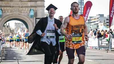 An Oxford professor ran the London Marathon dressed as an academic in 2 hours 55 minutes; he broke a Guinness record and raised money for a children's hospice