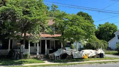 A Connecticut town paid $455,000 for a historic two-family home to create about 20 library parking spaces; a state preservation council has now voted to ask the attorney general to stop its demolition