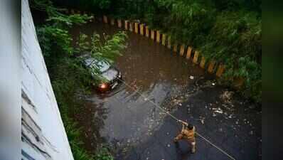 Car stuck in flooded underpass, family breaks windows to jump out