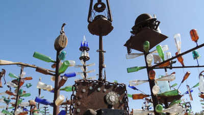 California cement worker Elmer Long turned discarded bottles and scrap metal into a desert art forest; as Route 66 turns 100, his two-acre ranch has 200 trees, 1,000+ bottles and visitors from around the world