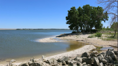 A Kansas couple wanted a beach without leaving home, so they turned two acres of their Olathe backyard into a 100,000-gallon lagoon with six waterfalls, tropical fish and a 23,000-pound boulder