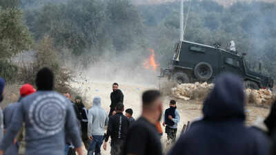 Israeli settlers attack Palestinian villages, torch cars and trees during olive harvest
