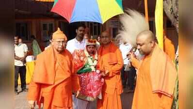 Little goddess gives blessings to devotees at puja