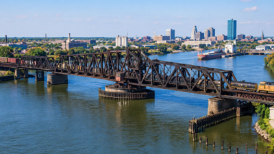 Toledo’s 1897 railroad swing bridge was bought for $1 in 2004; a new $65 million overhaul will replace nine fixed spans and reinforce the movable section to carry heavier 286,000-pound railcars