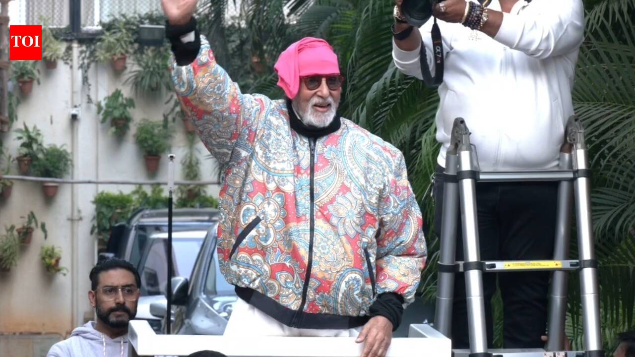 Amid bomb threat, Bachchan greets fans outside Jalsa, protective son Abhishek joins him