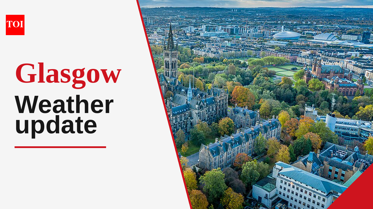 Glasgow cityscape under a sky with both sunny intervals and gathering rain clouds.