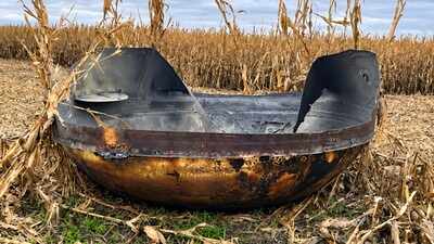 A Minnesota farmer harvesting corn found a mysterious 11-foot-wide metallic object in his field; space experts now suspect it is debris from a Chinese rocket launched in September, but its origin remains unconfirmed