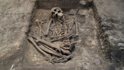 He was buried beneath a hearth, with a large stone pressed against his mouth and face, just one cm below the floor people walked on; researchers now suggest the 3,700-year-old burial was part of a magical ritual, not a punishment