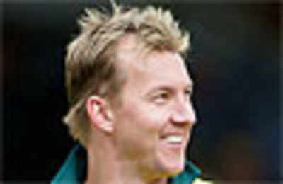 Australian fast bowler Brett Lee gives Andrew Symonds a Mohawk haircut made  famous by the Manchester United soccer player David Beckham as rain delays  the start of Australia's match against Pakistan |