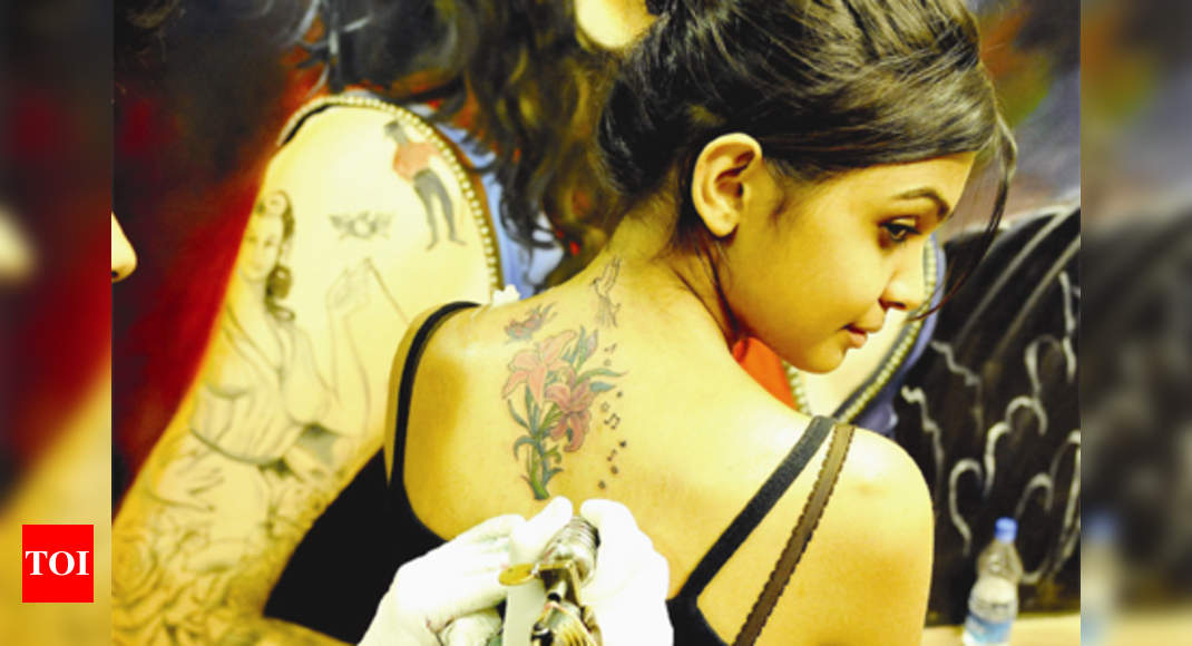 A tattoo in Devnagari script which reads ' Scarlett' adorns the arm... News  Photo - Getty Images