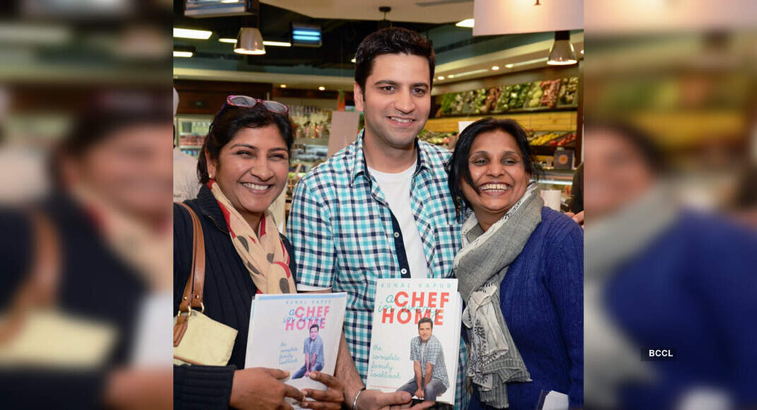 Chef Kunal Kapoor poses with food enthusiasts during a culinary ...