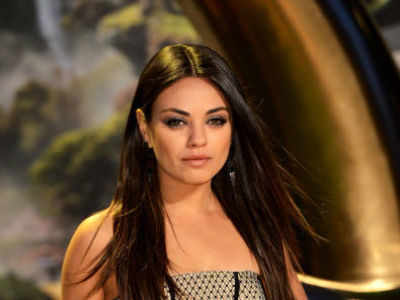 Mila Kunis covers baby bump at MTV Movie Awards