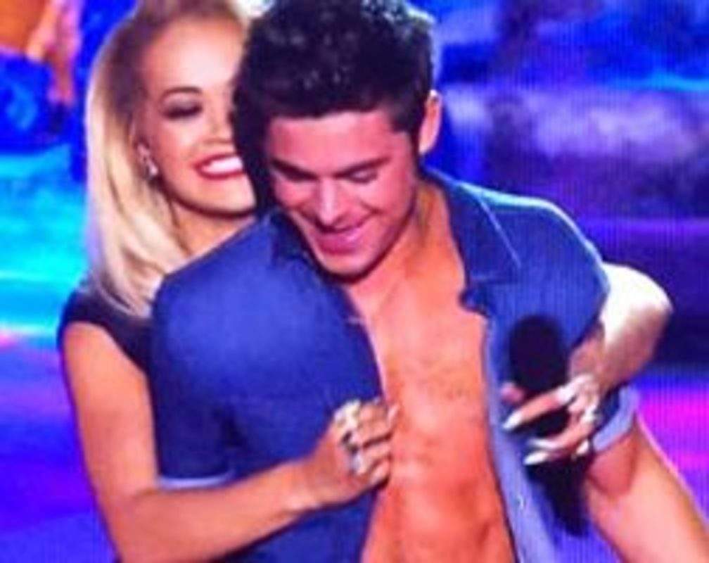
Rita Ora strips Zac Efron's shirt
