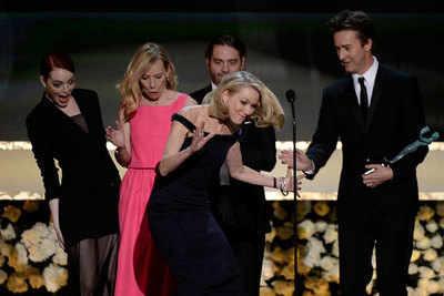 Naomi Watts trips on Emma Stone's skirt at Screen Guild Awards