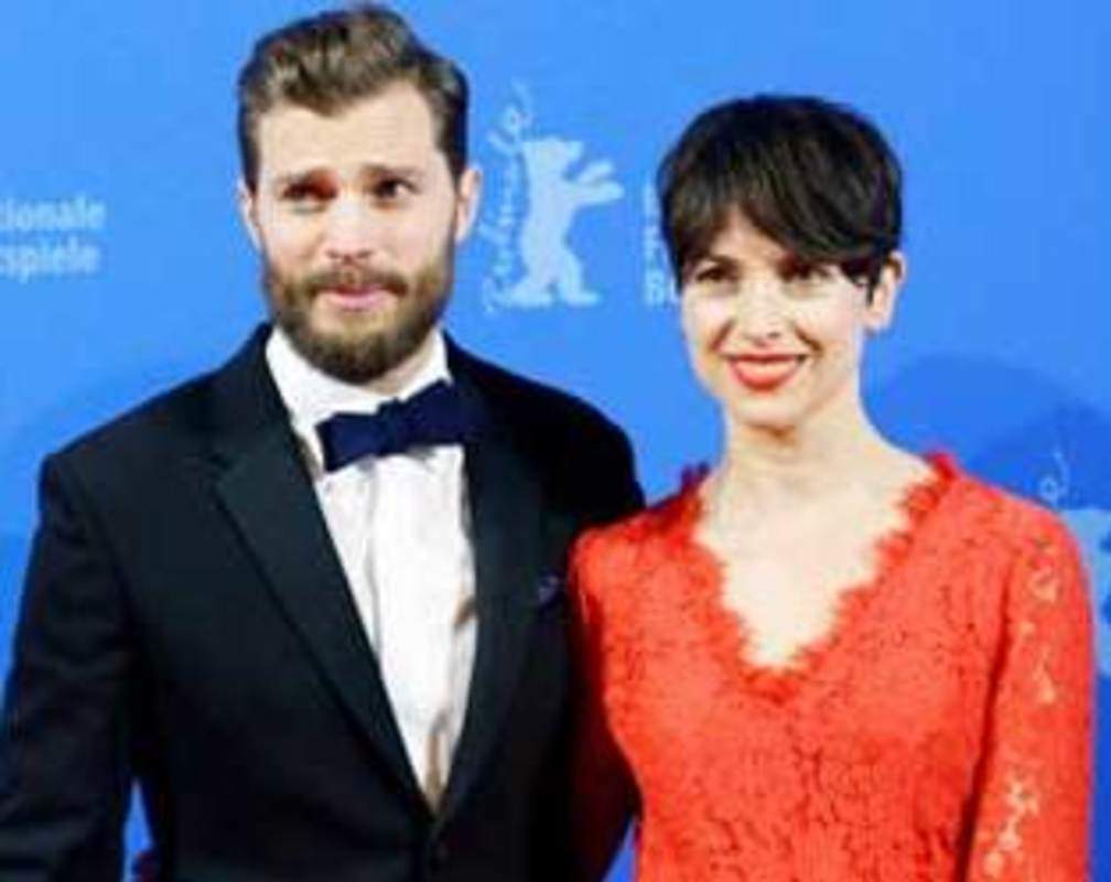 
Fifty Shades of Grey: Jamie Dornan throws a rose at a fan at world premiere

