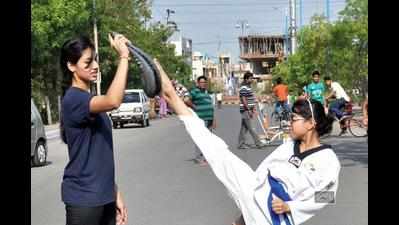 Young girls take Karate lessons during Raahgiri Day in Indore