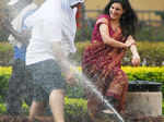 A French couple cool off at water sprinkler on a hot summer day Photogallery at Times of India