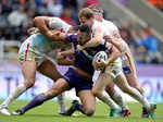Olivier Elima (L) Remi Casta (R) and Scott Dureau of Catalans Dragons tackle Jodie Broughton of Huddersfield Giants Photogallery - Times of India