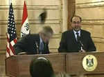 Iraqi journalist Muntadhar Al-Zaidi threw both of his shoes at the American President George W. Bush Photogallery - Times of India