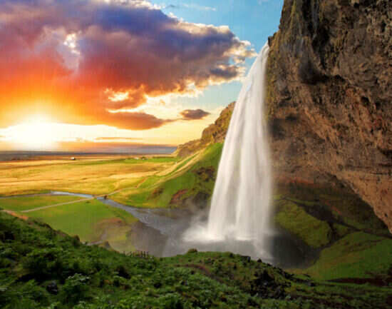 Walk behind Seljalandsfoss waterfall