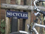 Funny shot of bicycle next to sign saying No Cycles