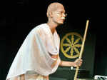 An artist performs during a play Gandhi Ne Kaha