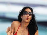 Kimora Lee Simmons raises the temperatures in red bikini and belly body chain