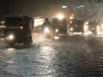 Vehicles wade through a water logged road