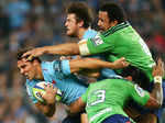 Nick Phipps of the Waratahs is tackled