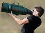 Photographer holds a bazooka type camera