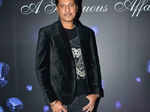 Bally Sagoo poses as he arrives for the amanté Lingerie Fashion