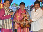 Chiranjeevi (R) presents an award during TSR TV9 National Film Awards