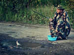 A man fishing in a pothole