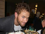 American model and actor Kellan Lutz poses with a cake