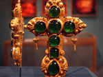 The twenty-two karat gold cross encrusted in precious emeralds