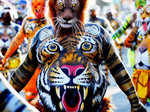 An artist with his body painted as tiger dances