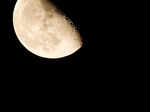 The moon rises over a cross at the GSP stadium