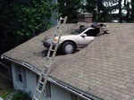 We have no idea how did this car fell on the roof of a house