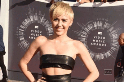 Miley Cyrus trying to be more conservative off stage