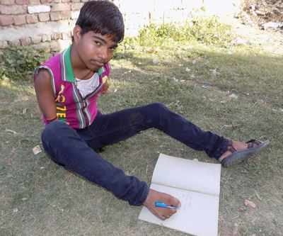16-year-old armless boy in UP aces Class 10 exams by writing with his feet