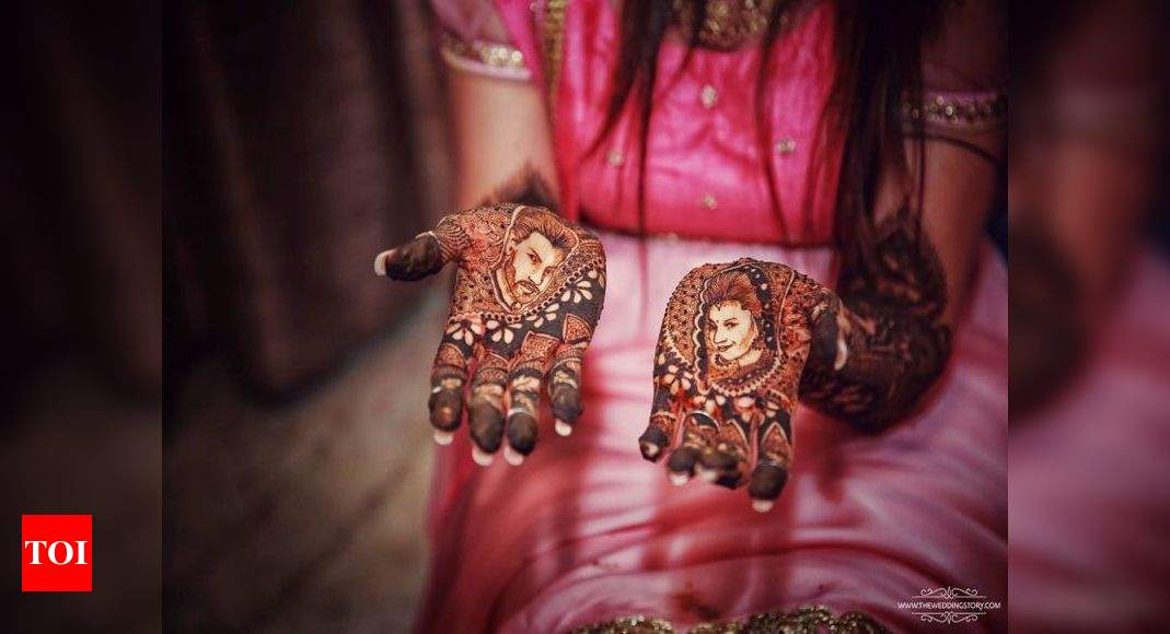 The groom holding the hand of the bride with henna mehndi at the wedding  ceremony Stock Photo - Alamy