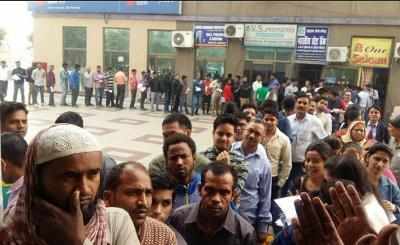 Humour: Man standing in a long queue outside bank hopeful of reaching counter by 30th December