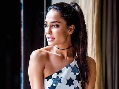 Lisa Haydon shows off baby bump in short white dress