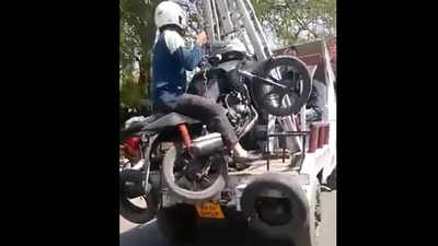 Rider towed away along with bike